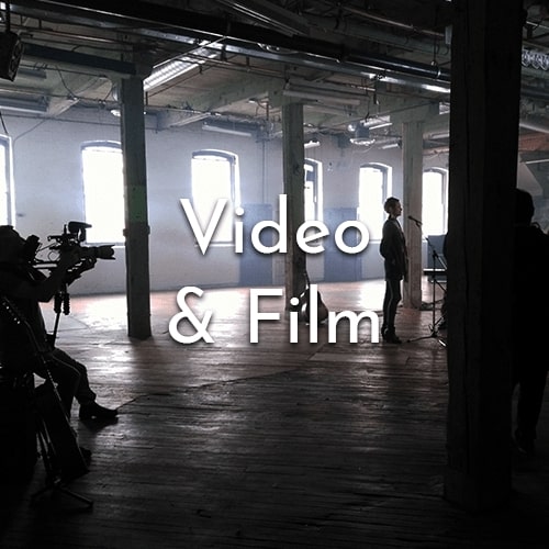 Shot in the event space of a videographer and the crew during filming. Text says "Video & Film".